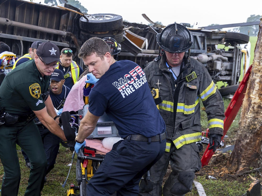Crews from Marion County Fire Rescue and the Marion County Sheriff's Office assist victims after a bus carrying farmworkers crashed and overturned early Tuesday Ocala, Fla.
