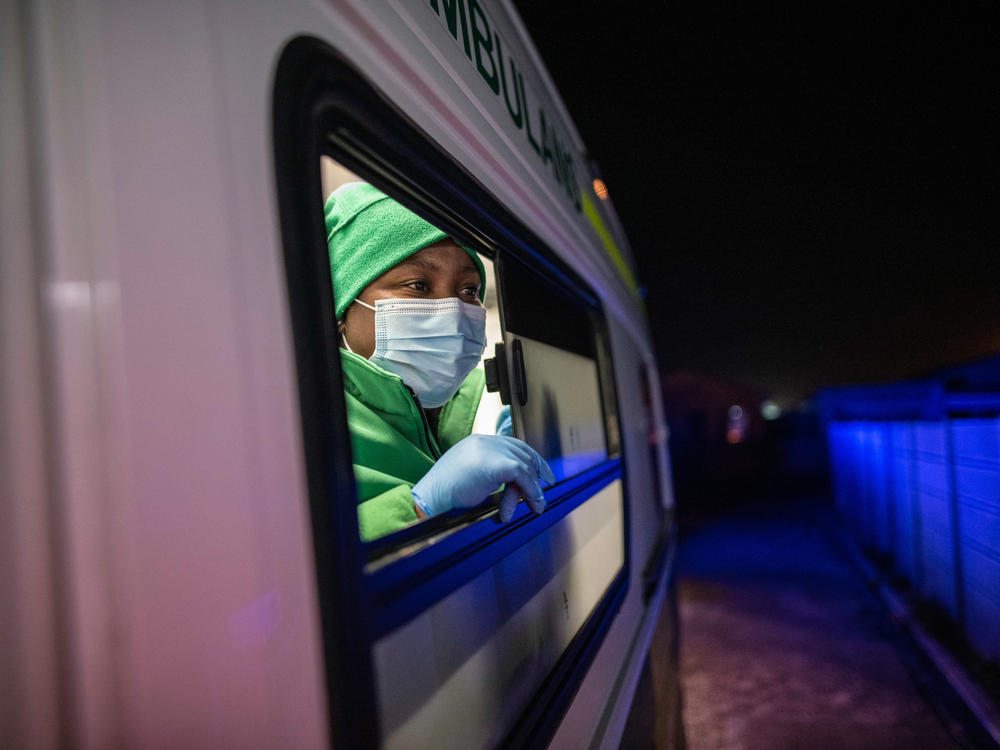 Paramedic Unathi Hayiyana peers out of an ambulance window after arriving at the home of a patient in a high-crime neighborhood in Cape Town. The risk of attack has forced paramedics to adopt a 