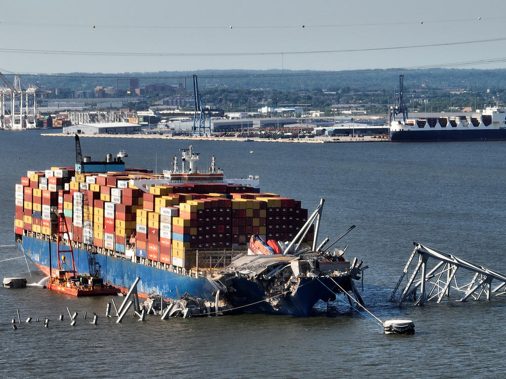In this aerial view, a steel truss from the destroyed Francis Scott Key Bridge that was pinning the container ship Dali in place was detached from the ship using a controlled detonation of explosives in the Patapsco River on Monday in Baltimore, Md.