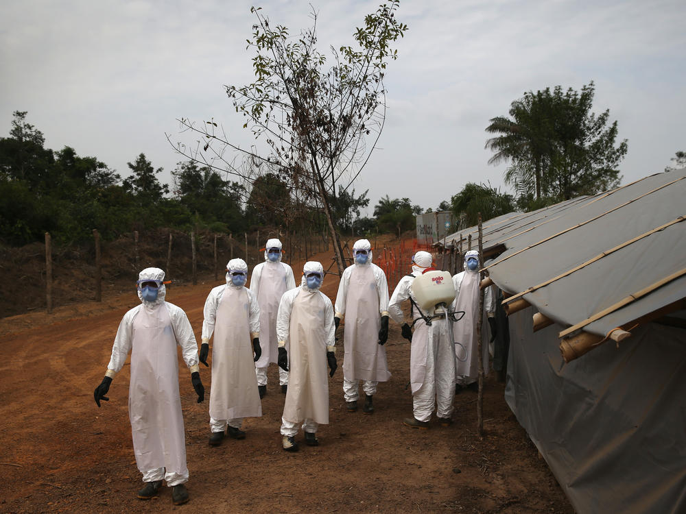 A burial team in Liberia awaits decontamination after performing 