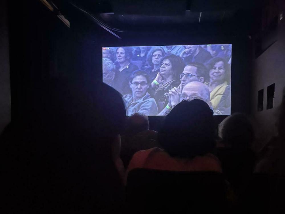 Viewers in Tel Aviv gather to watch the joint Memorial Day ceremony honoring victims from all sides of the Israel-Hamas conflict.