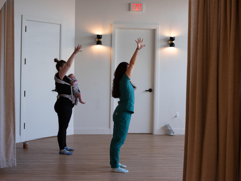 Arielle Weiner, 32, and her 5-month-old daughter (left) participate in a baby-wearing dance class.