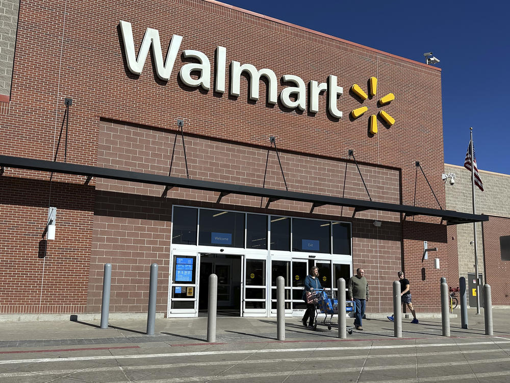 Shoppers exit a Walmart store, on Feb. 21, 2024, in Englewood, Colo. Walmart on Tuesday announced layoffs affecting several hundred jobs at the retail giant's campus offices.