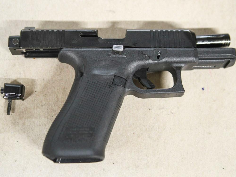 A Glock pistol with an illegal conversion device, sometimes referred to as a Glock switch. The small piece, which is illegal and not manufactured by Glock, can convert a semi-automatic pistol into a fully automatic one.