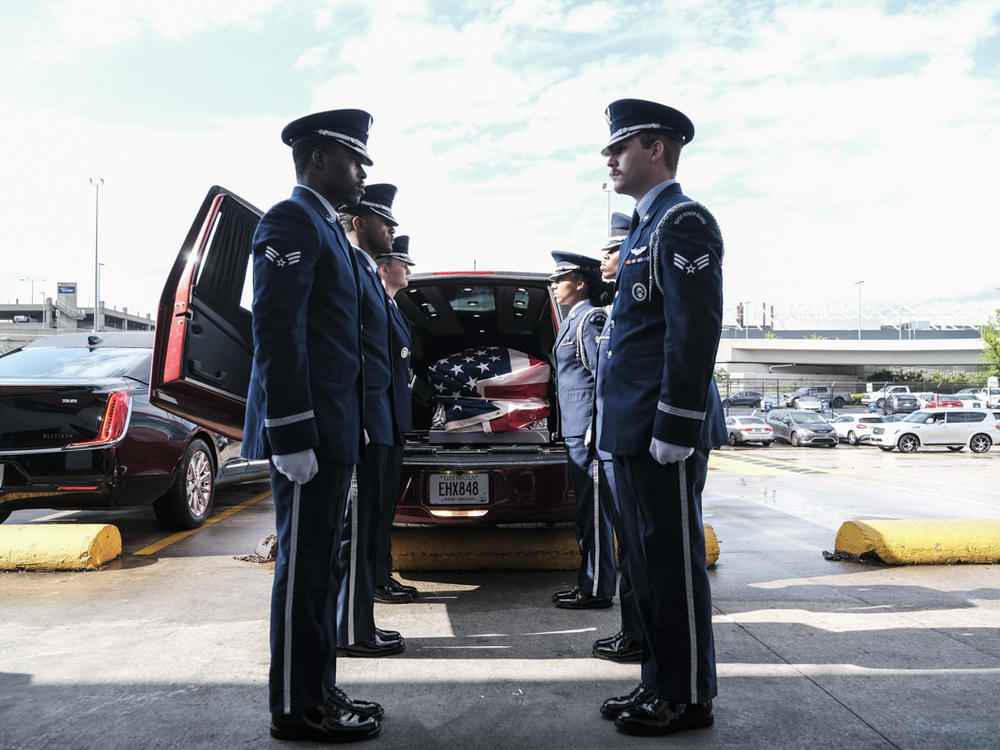 Members of the U.S. Air Force Honor Guard load the transfer case of Airman Roger Fortson into a hearse at the Hartsfield-Jackson Airport in Atlanta on Tuesday.