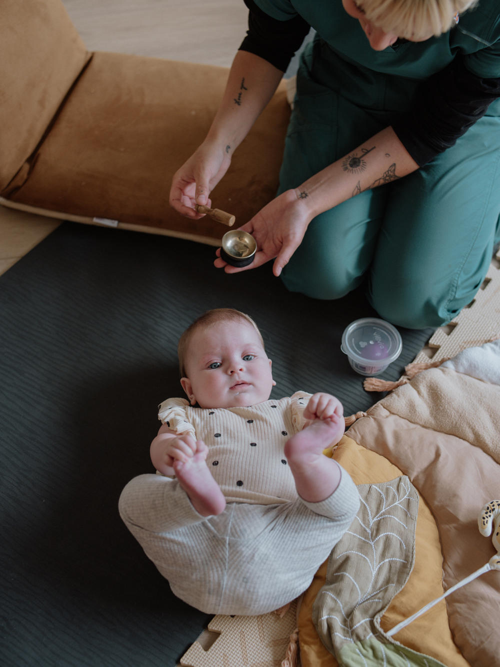 June Kelly, a certified postpartum doula and yoga teacher, uses a sound bowl to activate a baby's senses.