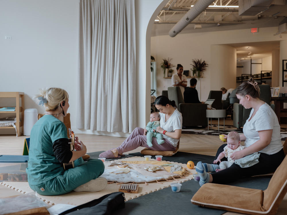 Mothers and their babies attend a baby music class facilitated by June Kelly, a postpartum doula and yoga instructor.