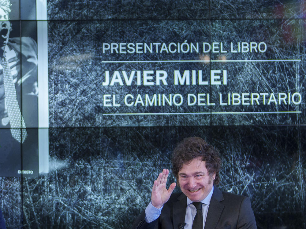 Argentina's President Javier Milei gestures as he presents his book 