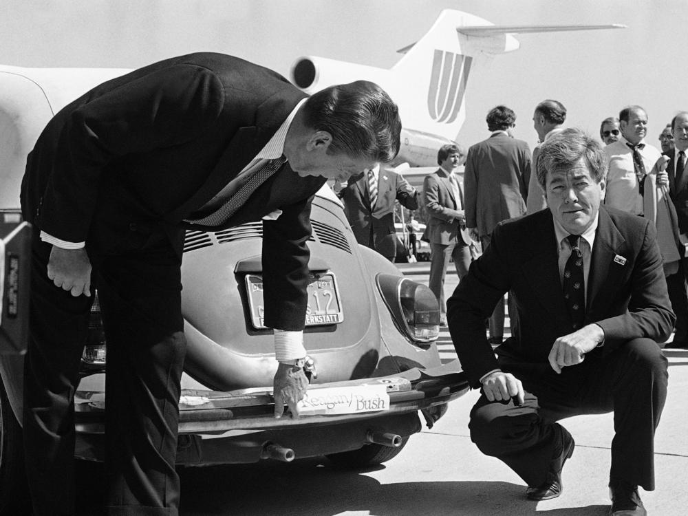 Republican presidential candidate Ronald Reagan admires the bumper sticker on the car of Rep. Pete McCloskey as the congressman looks on, right, in San Jose, Calif., Sept. 25, 1980.