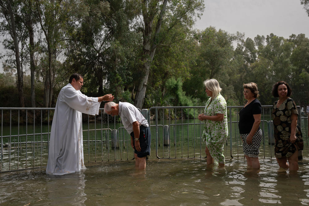 Christians from San Paolo, Brazil get blessed in the Jordan river in Israel on May 11, 2024.