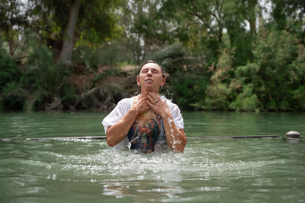 Valentina Miroshnochenko from Sochi immerses herself in the Jordan river in Israel on May 11, 2024.