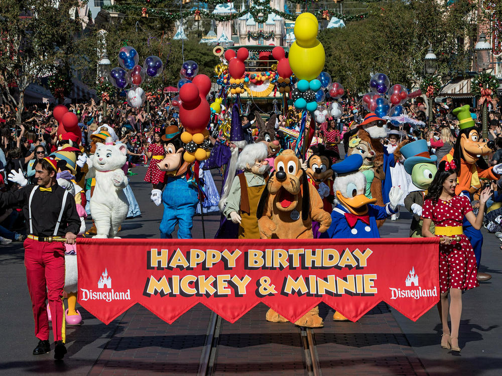 Disney characters lead a parade to celebrate Mickey Mouse's 90th birthday at Disneyland in November 2018.