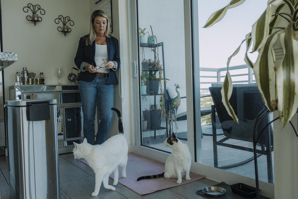 Rogozinski in her apartment with her two cats, Buddy and Sweet Girl.