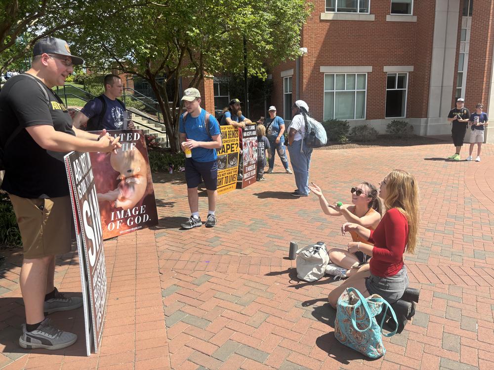 Jason Garwood, left, a Virginia pastor and anti-abortion activist who attended a conference hosted by the group Abolitionists Rising in April, argues with students at the University of North Carolina at Charlotte during an anti-abortion demonstration the group organized on the college campus.