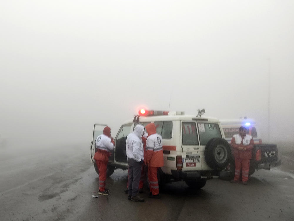 In this photo provided by Moj News Agency, rescue teams are seen on Sunday near the site of the incident of the helicopter carrying Iranian President Ebrahim Raisi in Varzaghan in northwestern Iran.