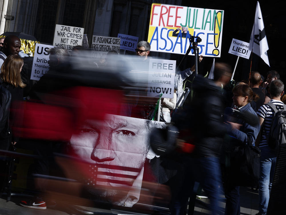 Supporters of WikiLeaks founder Julian Assange hold banners and placards as they protest in support of him, outside The Royal Courts of Justice, Britain's High Court, in central London on May 20, 2024.