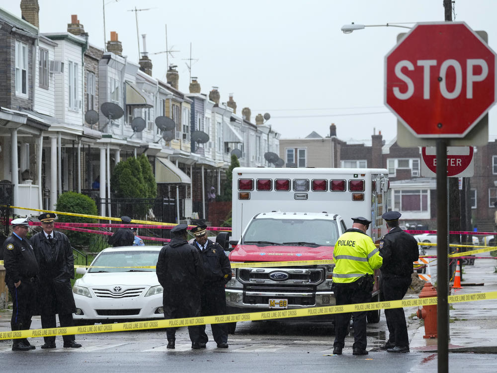 Law enforcement gather at the scene of a fatal shooting in Philadelphia on April 28, 2023.