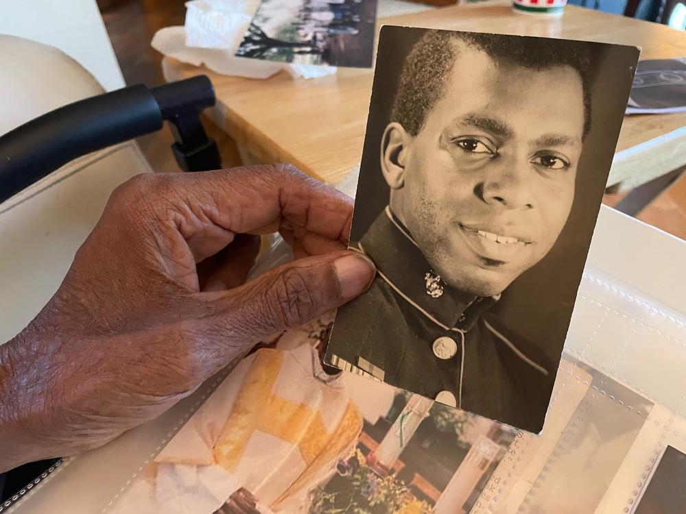 Robert Turner, Sr. holds a picture of himself as a young Marine.