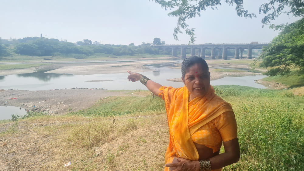 Sangeeta Govind Kamble, former chief municipal official in Koregaon village, on the banks of the Bhima River in western India. Across the river, an obelisk monument commemorates the 1818 Battle of Bhima Koregaon. Riots broke out there on the 200th anniversary in 2018.