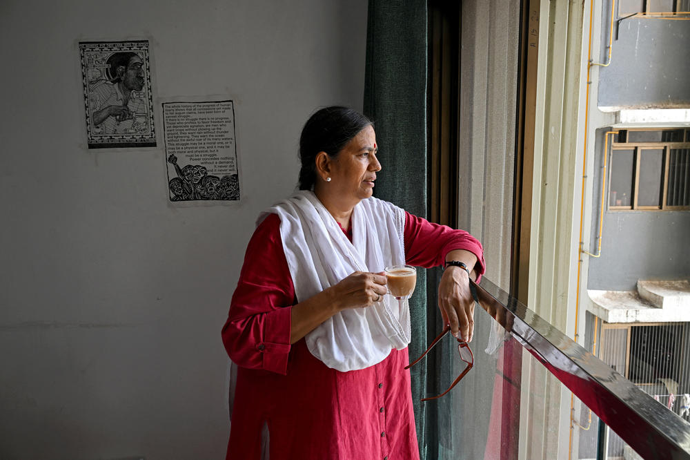 Activist and lawyer Sudha Bharadwaj drinks tea as she looks out the window of her residence in Mumbai on Oct. 19, 2023. In the summer of 2021, while incarcerated as one of those accused in the Bhima Koregaon case, she received a letter from Swamy in which he had written some of this last words.