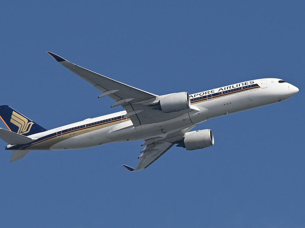 A Singapore Airlines plane flies after take off from Changi Airport in Singapore on Feb. 20. A Singapore Airlines flight from London to Singapore was diverted after it encountered severe turbulence.
