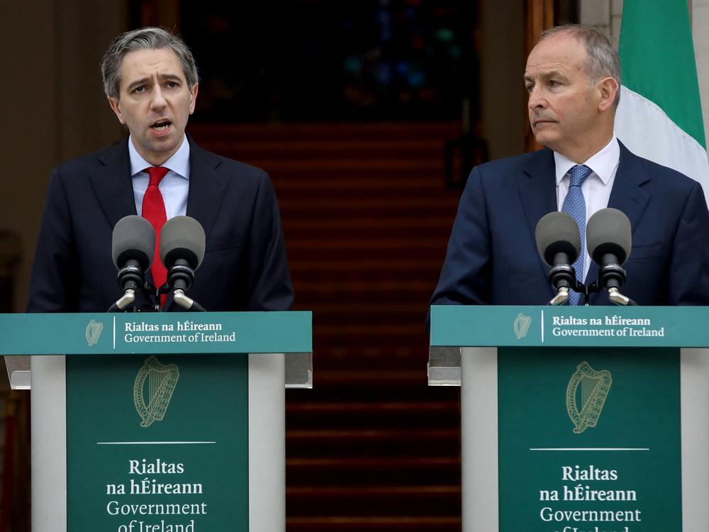 Ireland's Prime Minister Simon Harris, left, flanked by Ireland's Minister of Foreign Affairs Micheál Martin, speaks Wednesday in Dublin to announce Ireland's recognition of a Palestinian state.