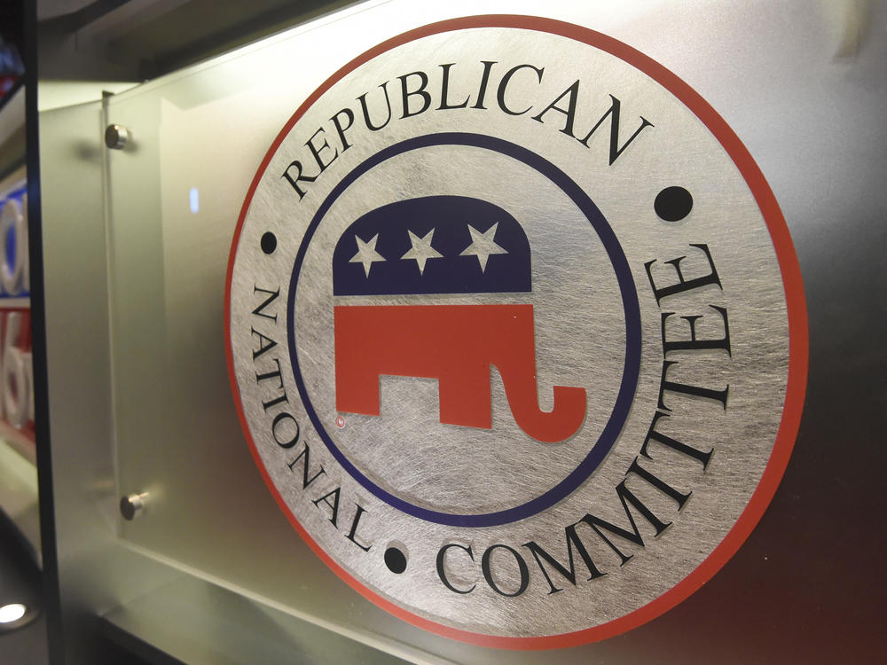 The Republican National Committee logo is shown on the stage as crew members work at the North Charleston Coliseum, Jan. 13, 2016, in North Charleston, S.C.