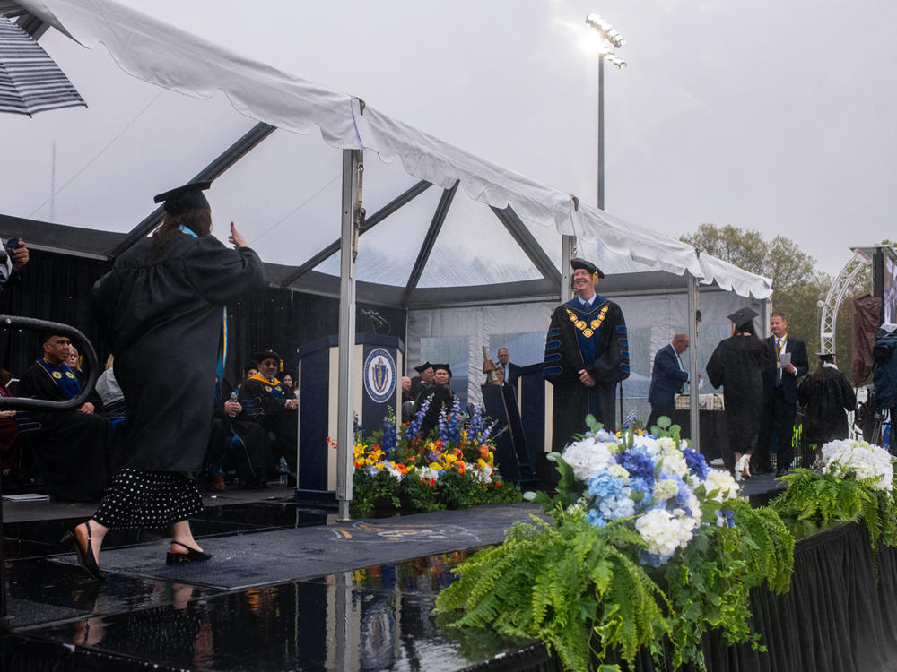 UMass Dartmouth students walked across the stage to accept their diplomas and cash, pictured on the table in the back.