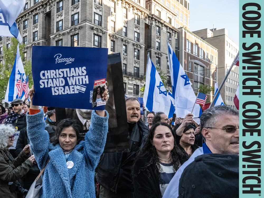 At a march in support of Israel, one woman holds a sign saying, 