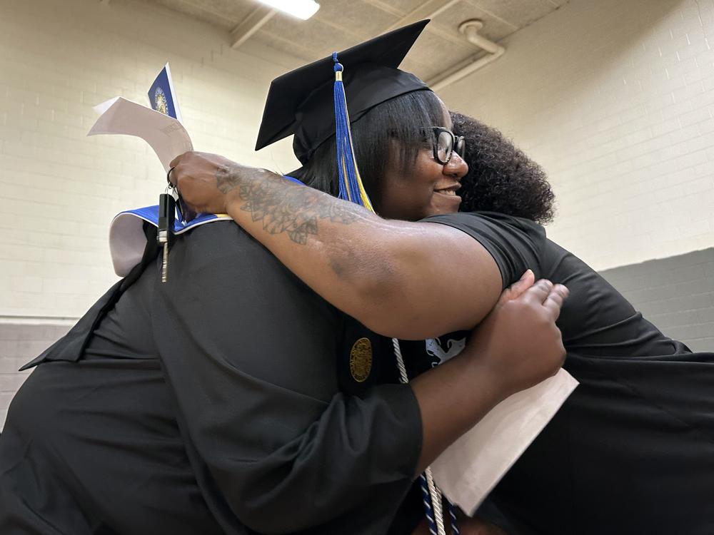 Janet Johnson, left, hugs her sister, Vanilla Murphy, at a graduation ceremony inside the prison gymnasium at the Maryland Correctional Institution for women.