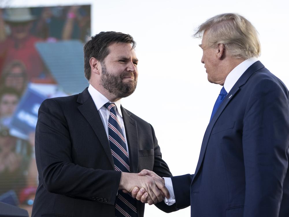 Sen. J.D. Vance of Ohio shakes hands with former President Donald Trump during a rally in Delaware, Ohio in 2023. Vance has ties to tech billionaires who are endorsing his vice presidential nomination.
