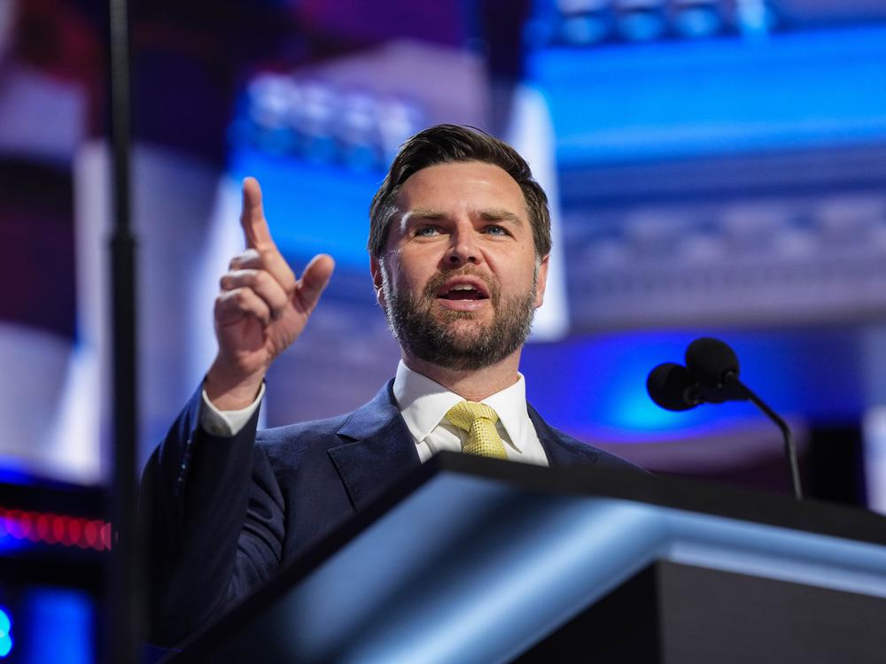 JD Vance, Donald Trump's vice presidential running mate, stands at a podium during a walkthrough for the 2024 Republican National Convention at the Fiserv Forum in Milkwaukee, WI.