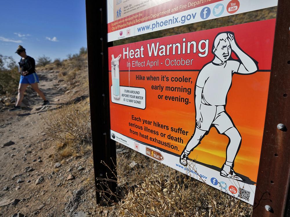 A hiker finishes her hike early to beat high temperatures on July 10, 2023, in Phoenix.