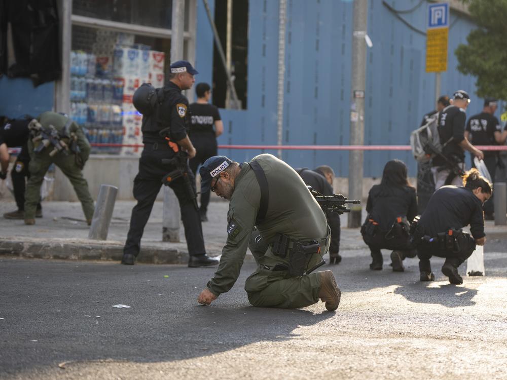 Israeli police investigate the scene of a drone attack in Tel Aviv, Israel on Friday. Yemen's Houthi militia claimed responsibility for the blast that left one dead and several injured.  
