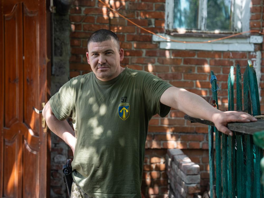 Yurii Lunyov, commander of the 2nd Rifle Battalion of the 57th Brigade, poses for a portrait outside a command center near Vovchansk on May 29.