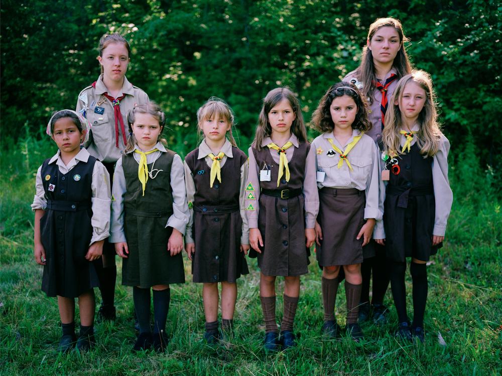 A group of <em>novachky</em>, female campers ages 6-11, stand at attention for a photograph, along with their two <em>sestrichky</em>, or 