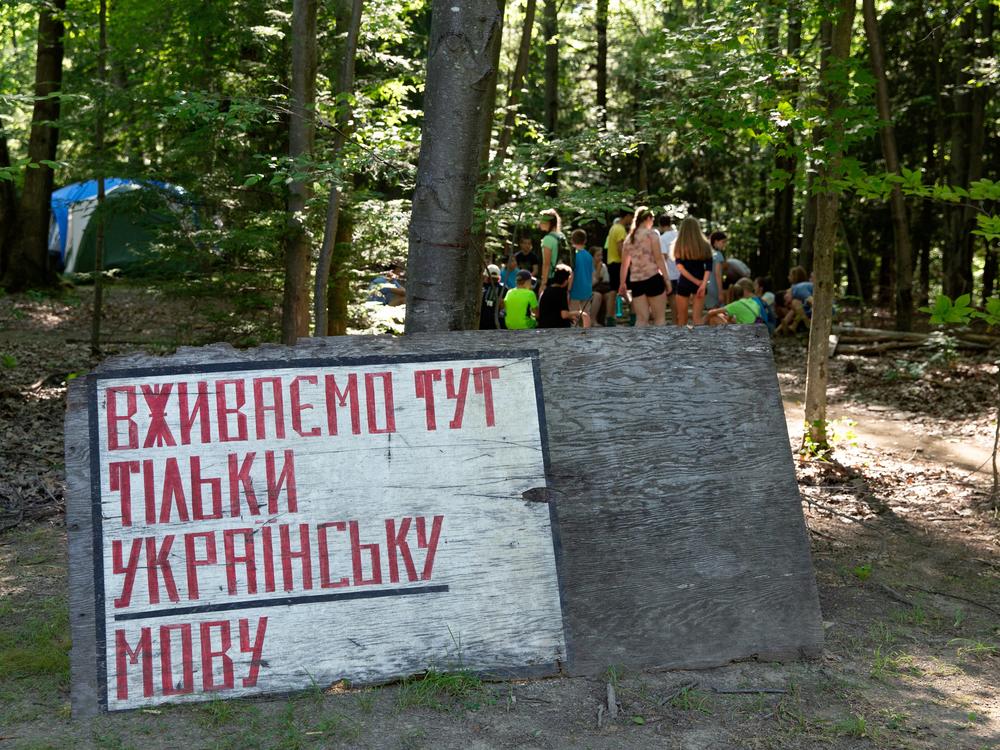 The camp is conducted in Ukrainian, and scouts are publicly rated on their language effort. This sign reads 