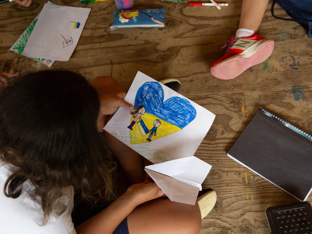 During arts and crafts time, familiar themes emerge every year, such as Ukrainian flag motifs, as illustrated here by Amelia, who wrote her name in Ukrainian.