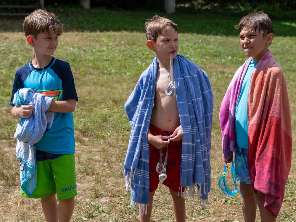 Three campers wait to go swimming on a hot sunny day in North Collins, N.Y.