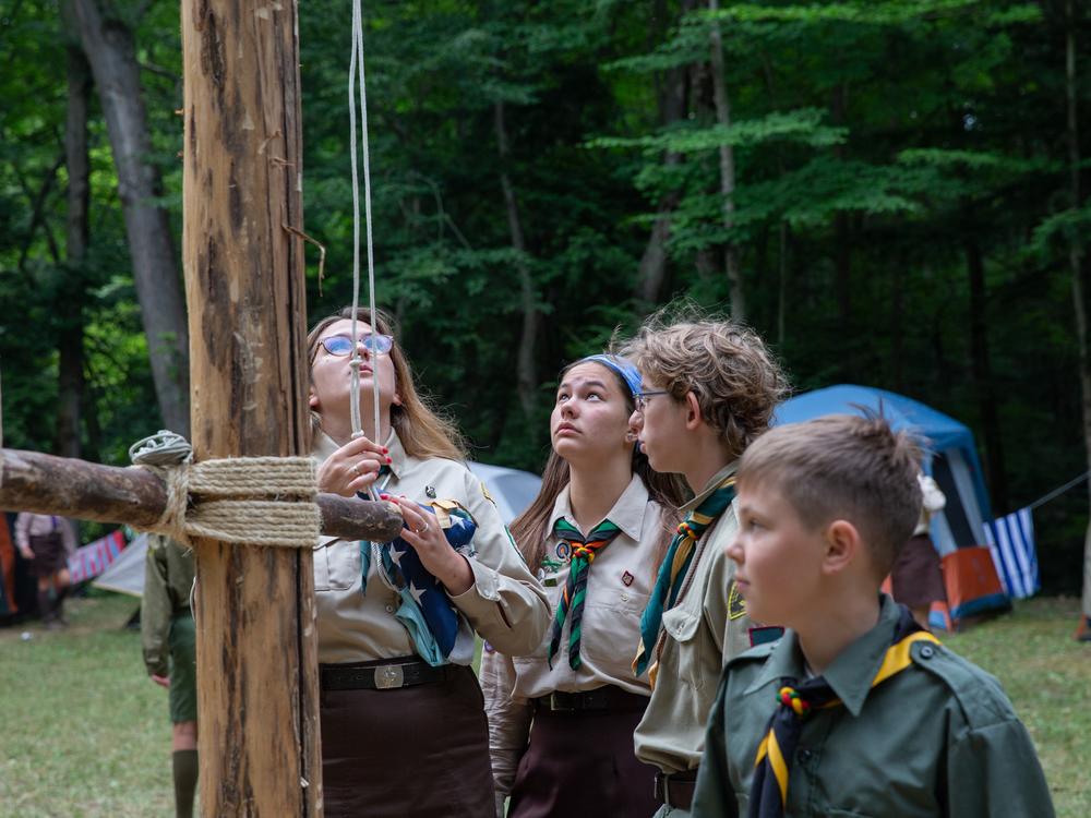 The <em>younatstvo</em>, campers ages 12-18, attend to the daily flag-raising ceremony on the hand-crafted flag pole.