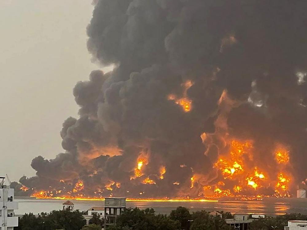 A handout picture obtained from Yemen's Huthi Ansarullah Media Center show a huge column of fire erupting following reported strikes by Israeli fighter jets in the Yemeni rebel-held port city of Hodeidah on Saturday. 