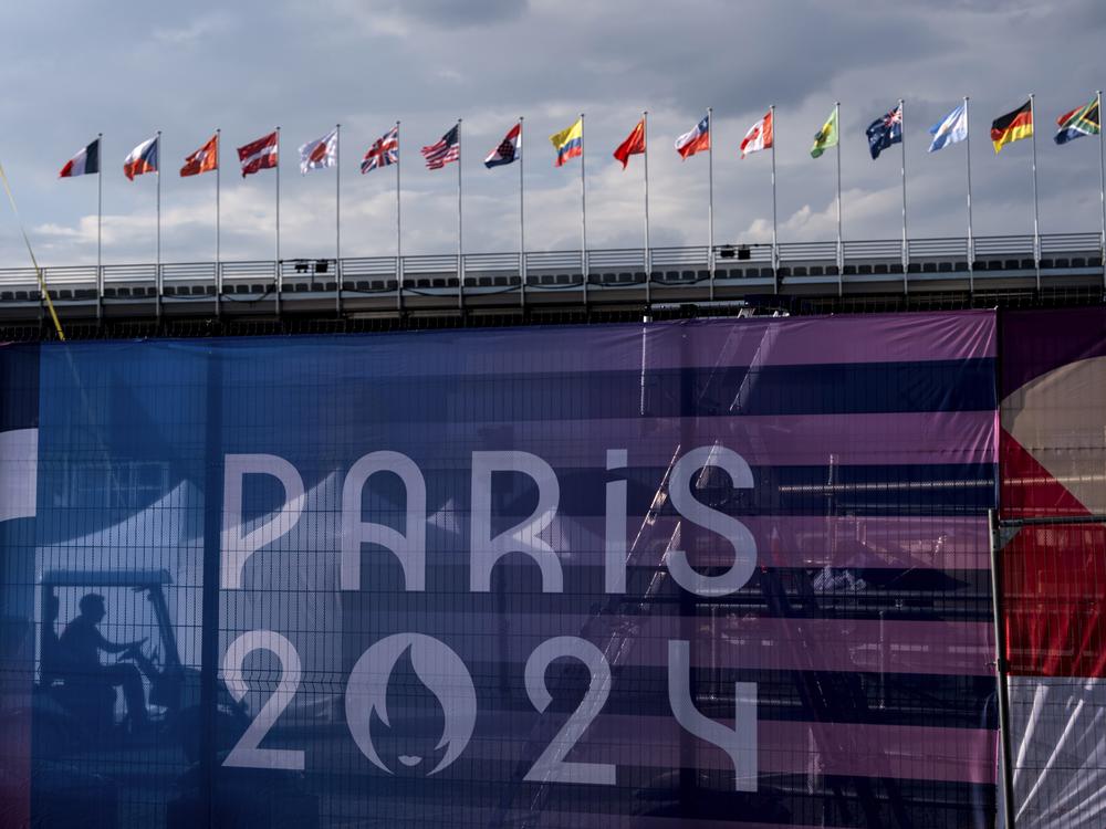 A worker drives a golf cart inside the competition venue for BMX freestyle ahead of the 2024 Summer Olympics, Friday, July 19, 2024, in Paris. (AP Photo/David Goldman)