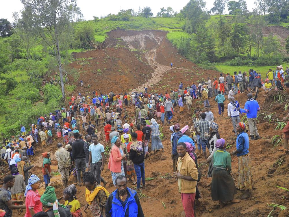 Hundreds of people gather at the site of a mudslide in the Kencho Shacha Gozdi district, Gofa Zone, southern Ethiopia, on Monday. At least 157 people were killed in mudslides in a remote part of Ethiopia that has been hit with heavy rainfall, according to local authorities.