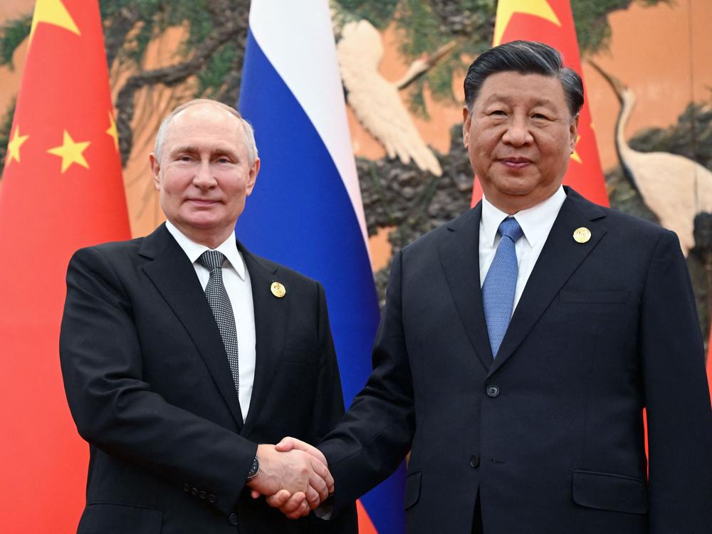 Russian President Vladimir Putin and Chinese President Xi Jinping shake hands during a meeting in Beijing on Oct. 18, 2023. 