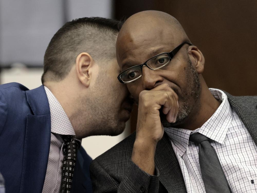 Christopher Dunn, right, listens to his attorney Justin Bonus during the first day of his hearing to decide whether to vacate his murder conviction in May at the Carnahan Courthouse in St. Louis. A Missouri judge on Monday overturned the conviction of Dunn, who has spent more than 30 years in prison for a killing he has long contended he didn’t commit.
