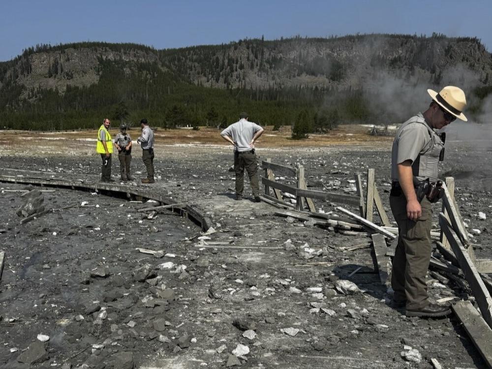 In this photo released by the National Park Service, park staff assess the damage to Biscuit Basin boardwalks after a hydrothermal explosion at Biscuit Basin in Yellowstone National Park, Wyo., on Tuesday.
