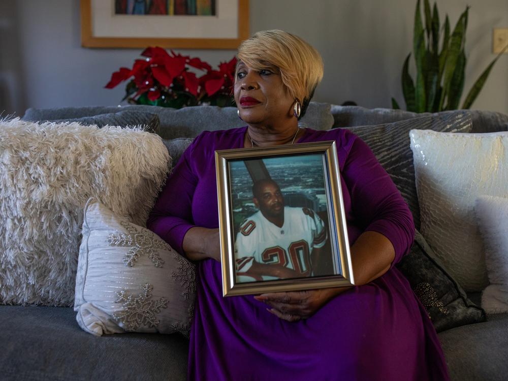 Melinda Mattocks-Ushry holds a photo of her brother Kelvin “Chuck” Mattocks at her home in New Bern, N.C., on Dec. 5, 2023. 