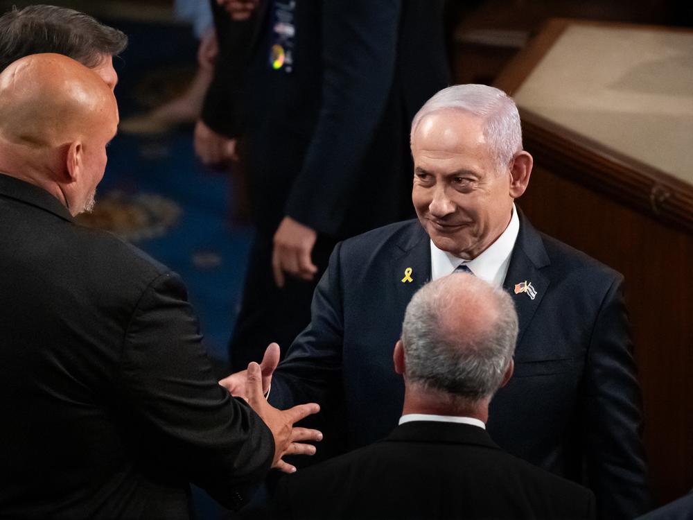 Israeli Prime Minister Benjamin Netanyahu shakes hands with staunchly pro-Israel Sen. John Fetterman, D-Pa., after delivering an address to a joint session of Congress on Wednesday.