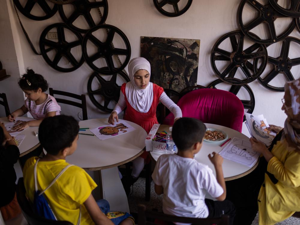 Sara Miliji, 12, from the border village of Naqoura, participates in an art class at a renovated movie theatre in the city of Tyre. Sara's family fled when their village was bombed. They now live along with hundreds of other families in a schoolroom turned into a shelter.<br>