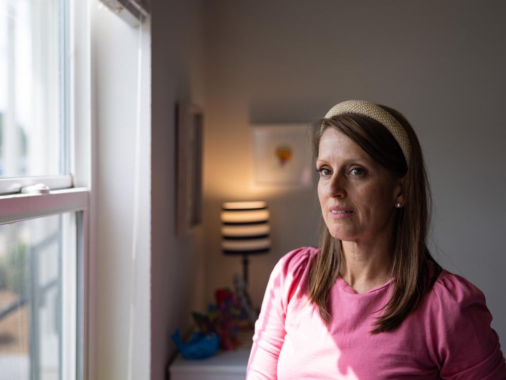 Amanda Whitworth stands by the window in her son's bedroom.
